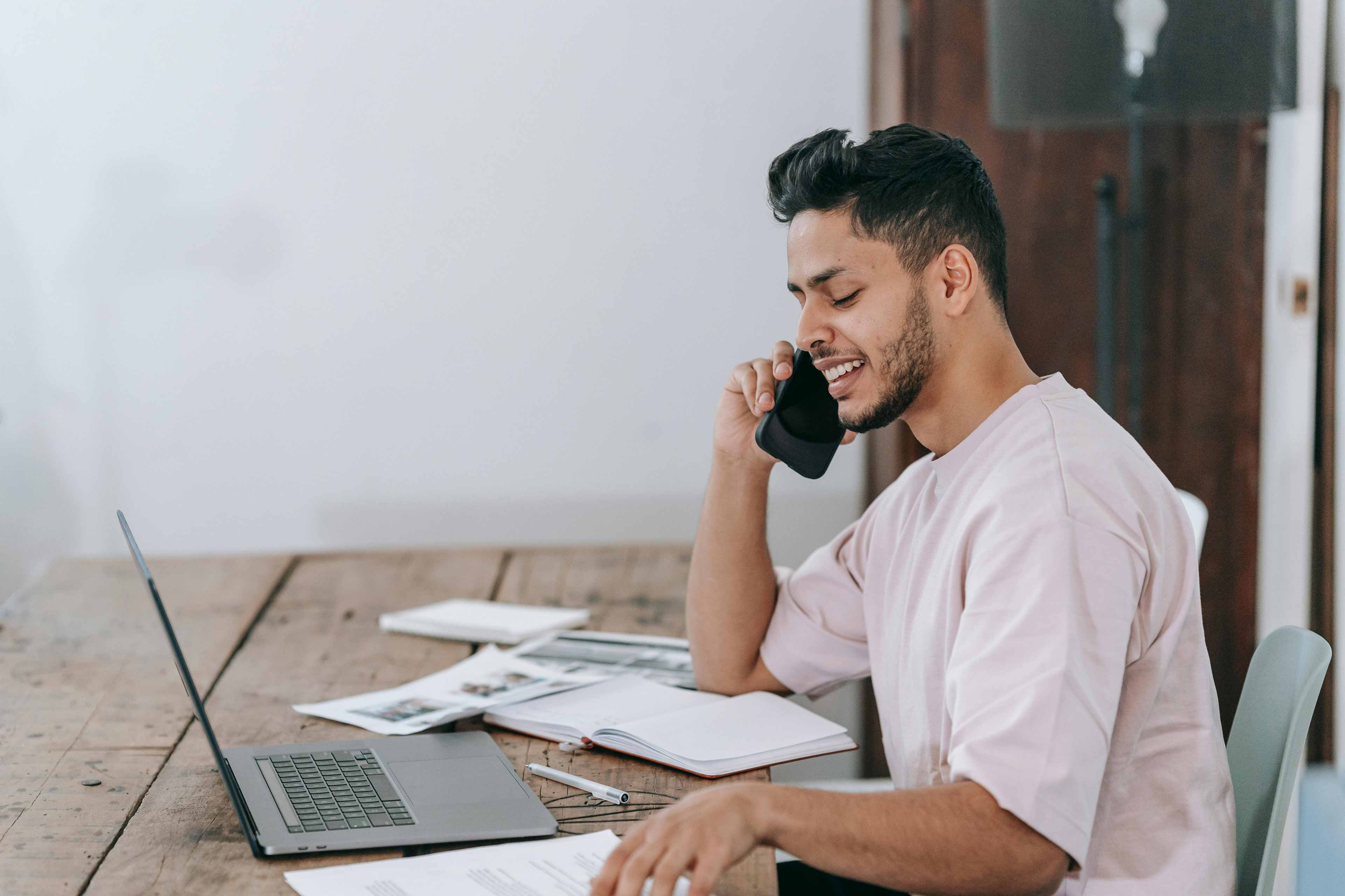 guy working on his computer while on the phone with the pdx tax and bookkeeping team