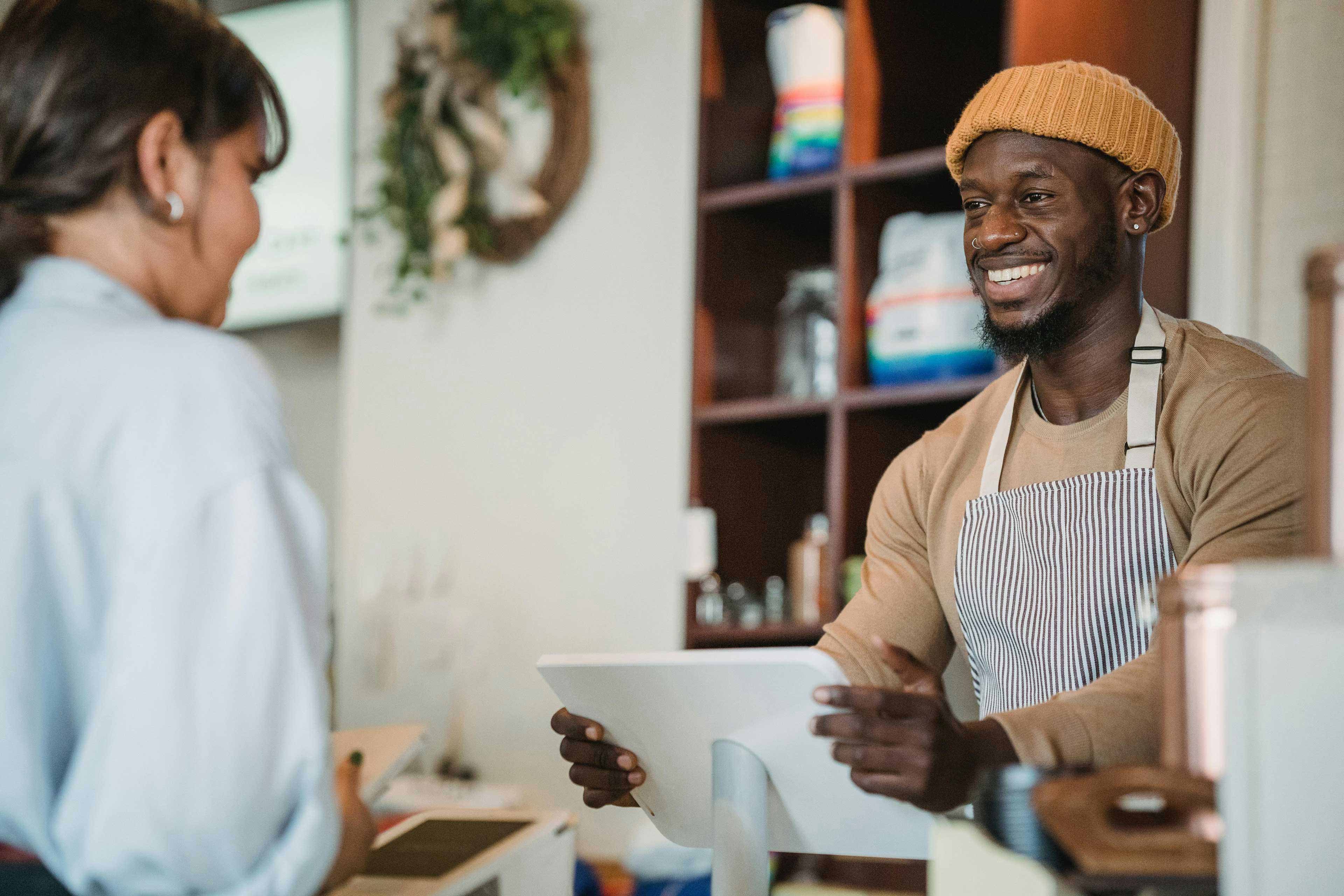 male person attending a store in front of a customer