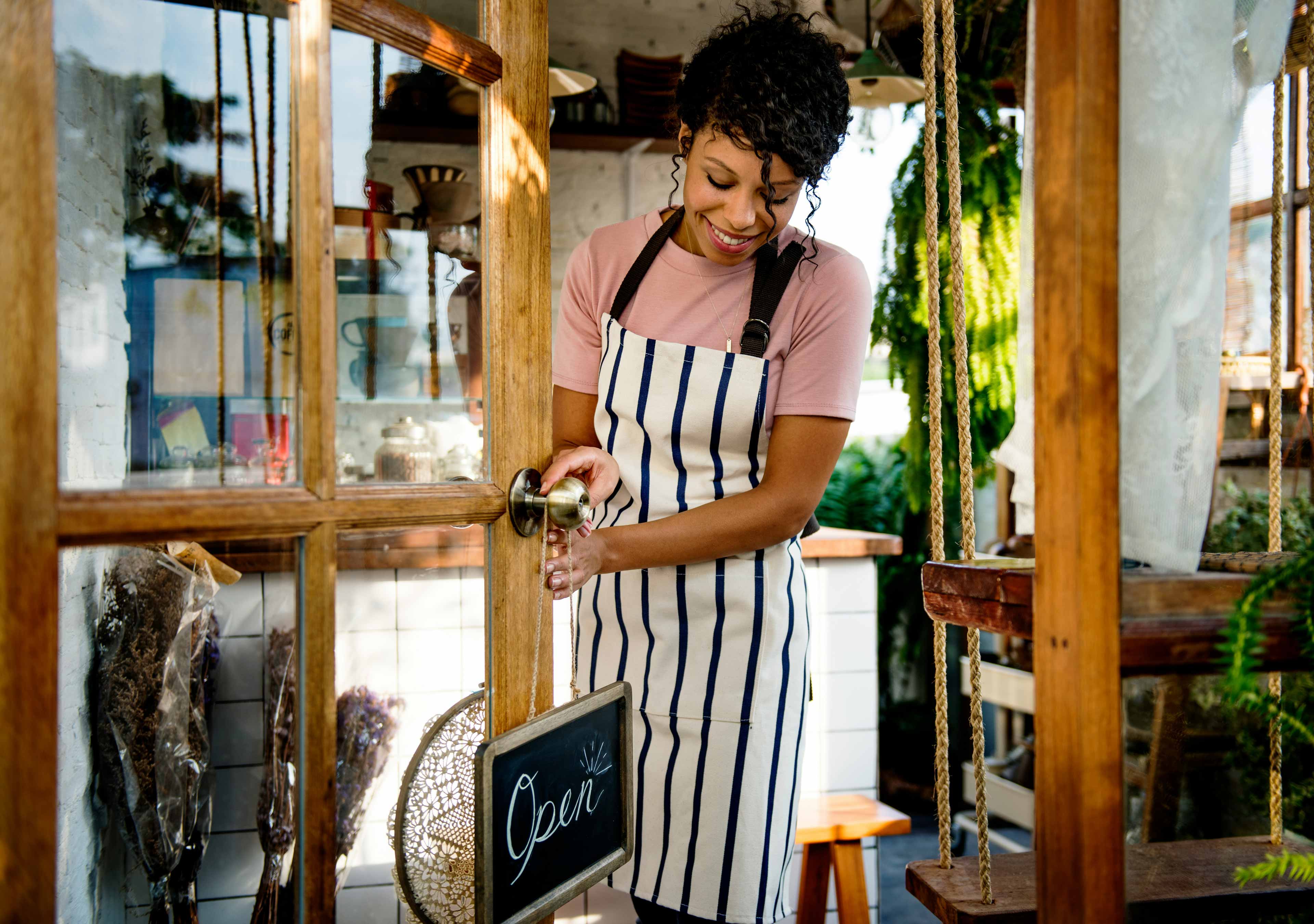 small business owner opening her shop